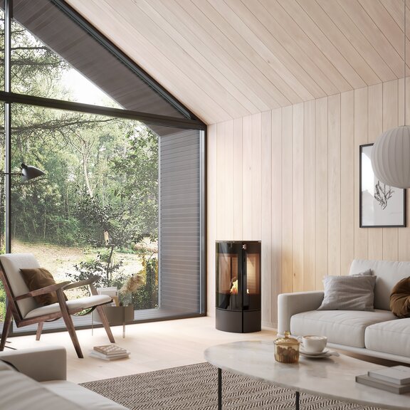 Bioethanol-Kaminofen CARO 90 BIO in Schwarz in einem hellen Wohnzimmer mit viel Holz